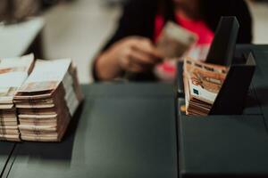 Sorted banknotes placed on the table after it is counted on the electronic money counting machine photo