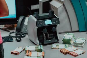 Sorted banknotes placed on the table after it is counted on the electronic money counting machine photo