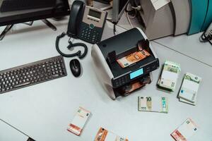 Sorted banknotes placed on the table after it is counted on the electronic money counting machine photo