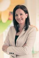 Young businesswoman smiling happy with arms crossed. Selctive focus photo