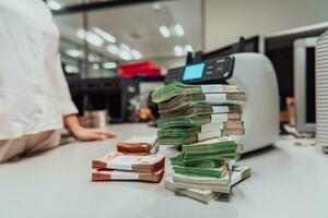 Sorted banknotes placed on the table after it is counted on the electronic money counting machine photo