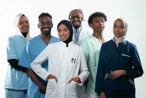 Team or group of a doctor, nurse and medical professional coworkers standing together. Portrait of diverse healthcare workers looking confident. Middle Eastern and African, Muslim medical team. photo