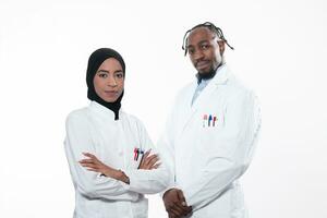 Closeup front view of group of mixed age doctors and nurses standing side by side and looking at the camera. Young Middle Eastern female in a team with African American male doctor. photo