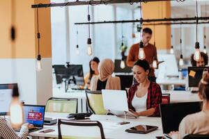 Multiethnic group of employees working in a marketing company. A group of colleagues is working on a project in modern offices photo
