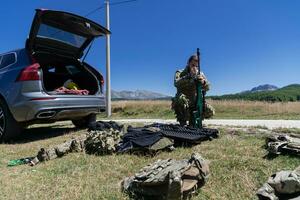 Special operations soldiers team preparing tactical and communication gear for action battle. Long distance sniper team in checking gear for action photo