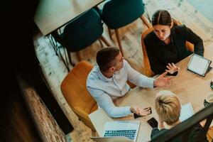 Top view of photo businesspeople smiling cheerfully during a meeting in a coffee shop. Group of successful business professionals working as a team in a multicultural workplace.