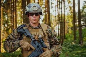 A modern warfare soldier on war duty in dense and dangerous forest areas. Dangerous military rescue operations photo