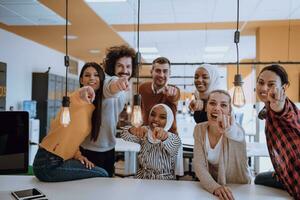 Multiethnic group of employees working in a marketing company. A group of colleagues is working on a project in modern offices photo