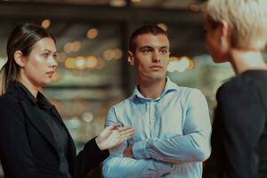 Photo of a business team of young people discussing business ideas in a modern urban environment. Selective focus