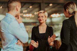 Photo of a business team of young people discussing business ideas in a modern urban environment. Selective focus