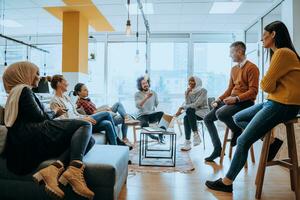 Young designer giving some new ideas about project to his partners in conference room. Business people discussing over new business project in office. photo