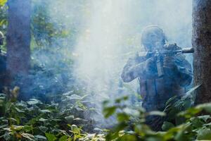 A modern warfare soldier on war duty in dense and dangerous forest areas. Dangerous military rescue operations photo