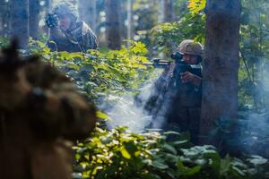 A group of modern warfare soldiers is fighting a war in dangerous remote forest areas. A group of soldiers is fighting on the enemy line with modern weapons. The concept of warfare and military conflicts photo