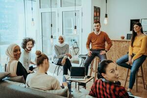 Young designer giving some new ideas about project to his partners in conference room. Business people discussing over new business project in office. photo