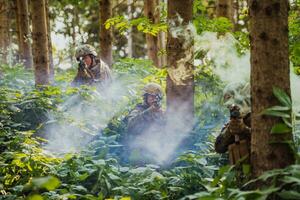 A group of modern warfare soldiers is fighting a war in dangerous remote forest areas. A group of soldiers is fighting on the enemy line with modern weapons. The concept of warfare and military conflicts photo