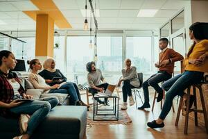 Young designer giving some new ideas about project to his partners in conference room. Business people discussing over new business project in office. photo