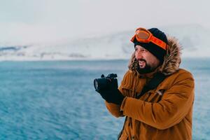 A photographer in the cold Skavdinava regions tries to take a photo for journalism in a strong winter storm