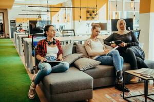 Young designer giving some new ideas about project to his partners in conference room. Business people discussing over new business project in office. photo