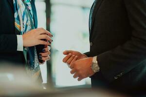 Photo of a businessman and businesswoman discussing business projects in a modern corporation. Selective focus