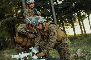 Modern Warfare Soldiers Squad are Using Drone for Scouting and Surveillance During Military Operation in the Forest. photo