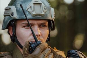 Modern Warfare Soldier Commander Officer Talking Portable Radio Station and Give Orders Subdivision Squad photo