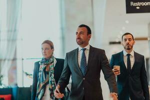 Photo of a business team in suits walking in a modern corporation. Successful business team. Selective focus
