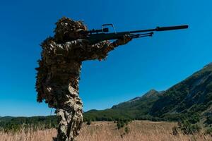 Army soldier holding a sniper rifle with scope and walking in the forest. war, army, technology and people concept. photo