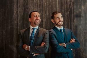 Portrait of two businessman in a suit with his arms crossed in a modern office building. Selective focus photo