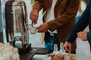 Close-up photo of businessmen serving themselves in a modern hotel during a dinner party. Selective focus