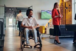 A businessman in a wheelchair occupies a hallway within a modern startup coworking center, embodying inclusivity and determination in the business environment photo