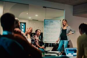 A pregnant businesswoman leads a creative meeting of a diverse business team in a modern coworking photo