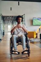 A businessman in a wheelchair occupies a hallway within a modern startup coworking center, embodying inclusivity and determination in the business environment photo