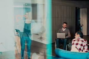 A pregnant businesswoman leads a creative meeting of a diverse business team in a modern coworking photo