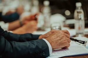 Close-up photo of businessmen who are at a meeting and business meeting in a modern hall