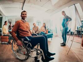 A pregnant businesswoman leads a creative meeting of a diverse business team in a modern coworking photo