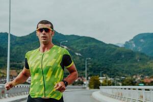 An athlete running a marathon and preparing for his competition. Photo of a marathon runner running in an urban environment