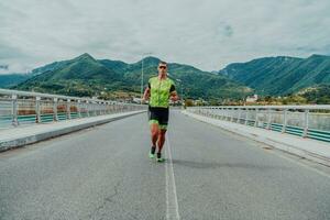 An athlete running a marathon and preparing for his competition. Photo of a marathon runner running in an urban environment