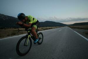 triathlon athlete riding bike at night photo