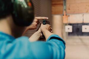 The trainer explaining to the man how to use the gun. Training in the shooting range photo