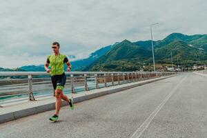 An athlete running a marathon and preparing for his competition. Photo of a marathon runner running in an urban environment