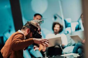 Business persons with a disability at work in modern open space coworking office on team meeting using virtual reality goggles. photo