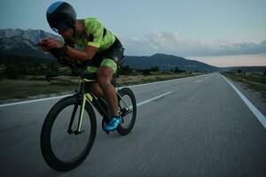 triathlon athlete riding bike at night photo