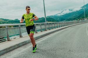 An athlete running a marathon and preparing for his competition. Photo of a marathon runner running in an urban environment