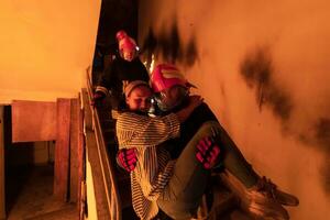 Brave Fireman Descends Stairs of a Burning Building and Holds Saved Girl in His Arms. Open fire and one Firefighter in the Background. photo