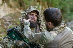 Special operations soldiers team preparing tactical and communication gear for action battle. Long distance sniper team in checking gear for action photo