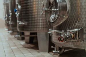 Modern wine distillery and brewery with brew kettles pipes and stainless steel tanks photo