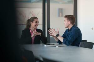 A group of young entrepreneurs are sitting in a modern office and agreeing on new business plans photo