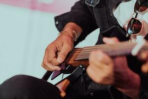 Practicing in playing guitar. Handsome young men playing guitar photo