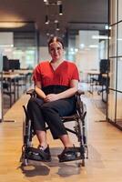 A modern young businesswoman in a wheelchair is surrounded by an inclusive workspace with glass-walled offices, embodying determination and innovation in the business world photo