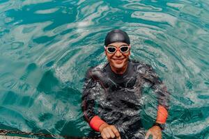 Triathlete swimmer portrait wearing wetsuit on training photo